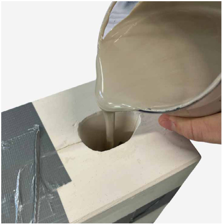Pouring slip into the plaster mould