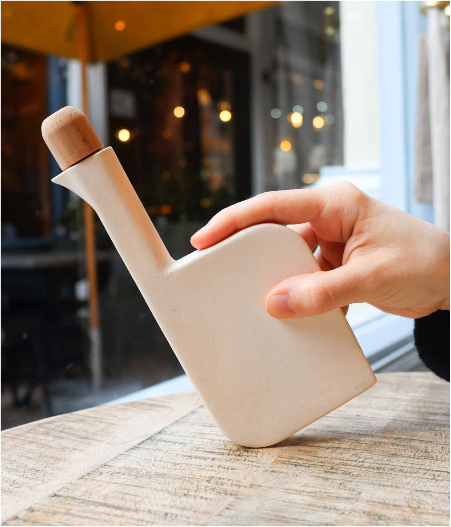 Ardea held mid-pour in a café