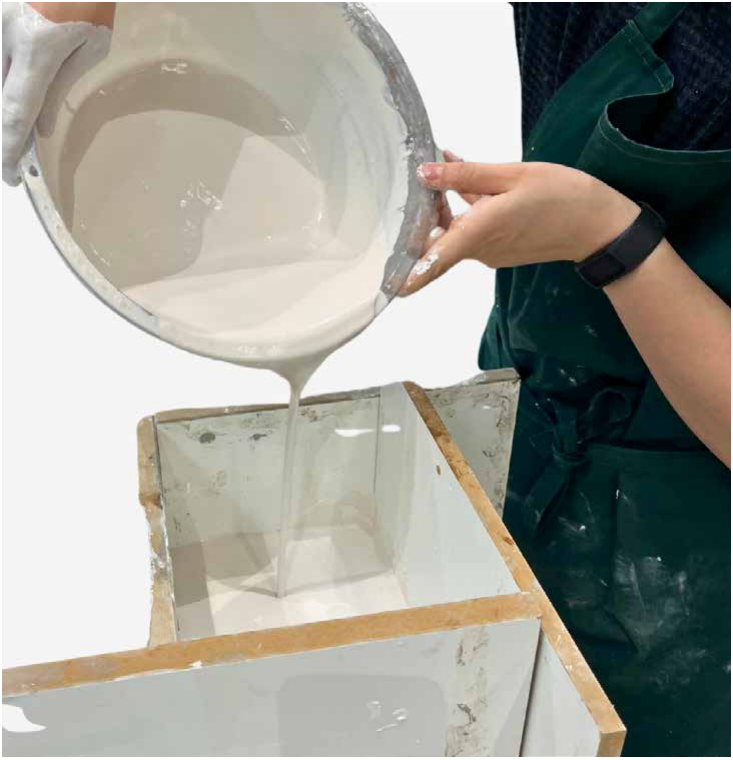 Pouring plaster over the master model