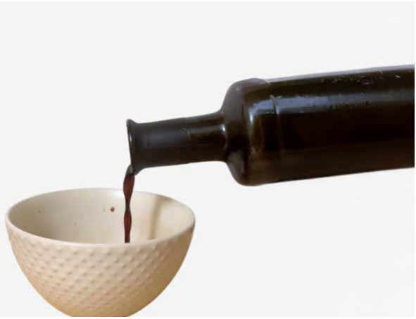 Pouring vinegar from a wide bottle neck