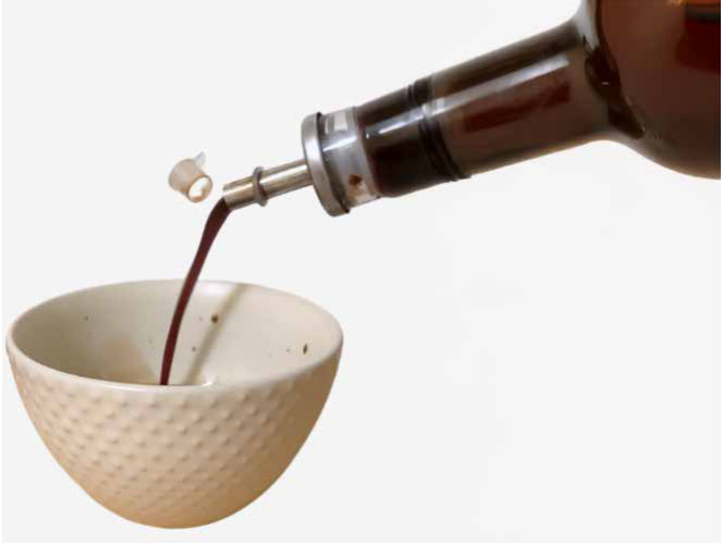 Pouring vinegar through a metal spout