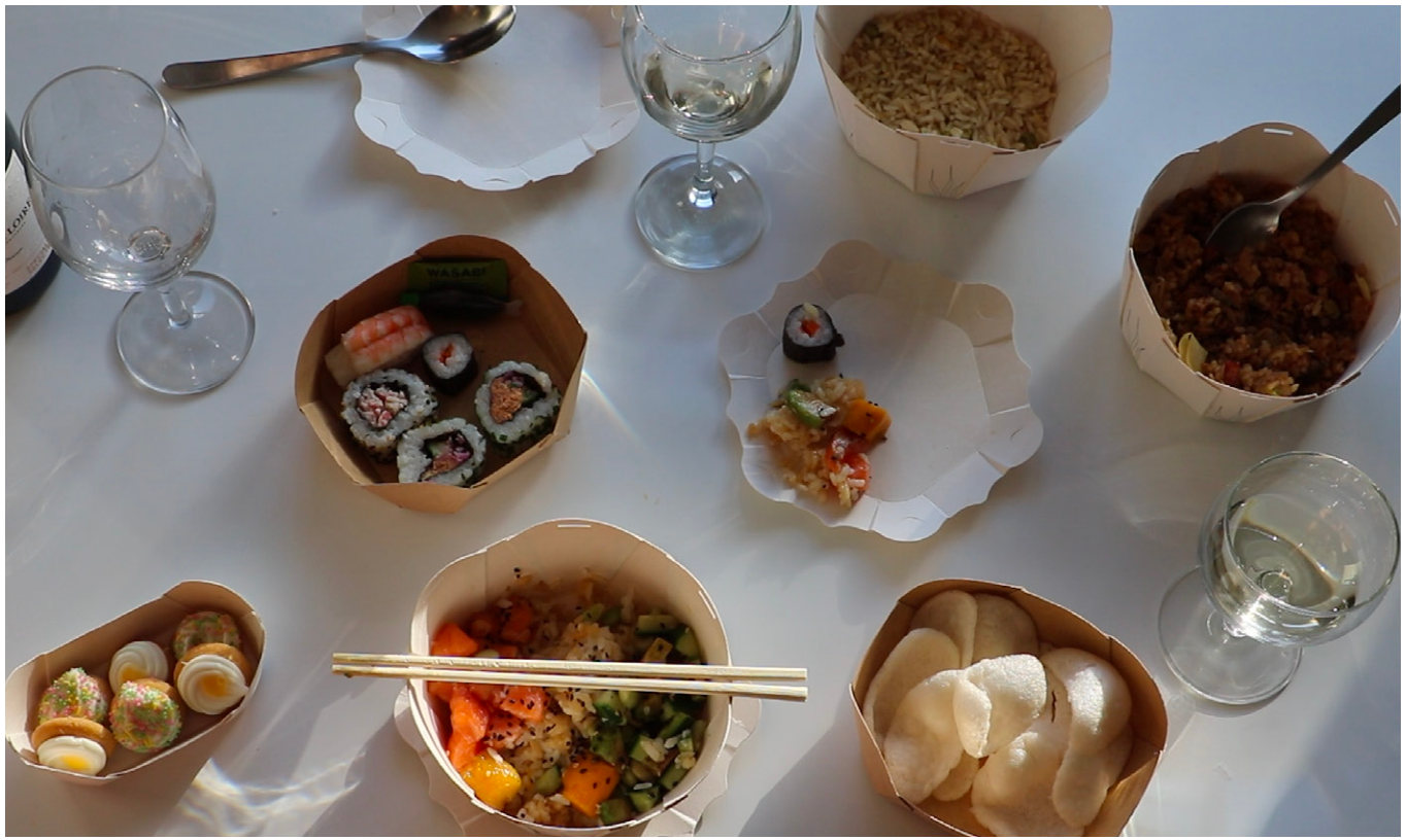 A table of sushi and noodles in Nelumbo containers