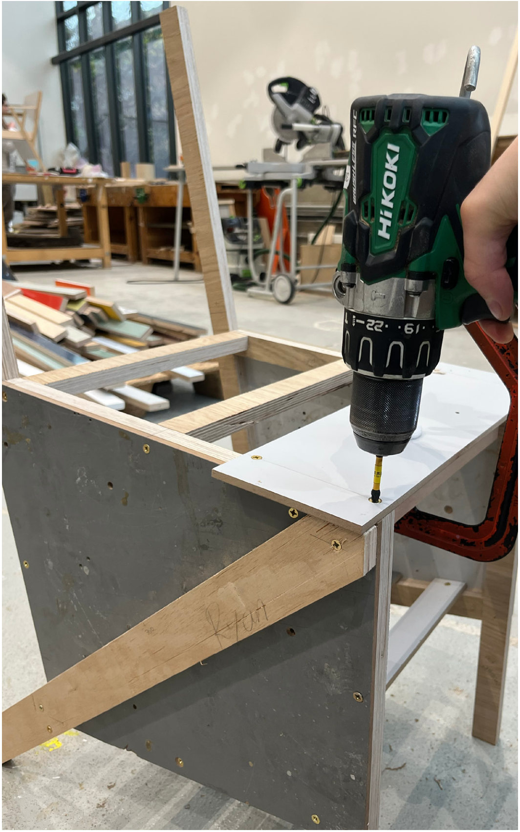 Screwing the seat panel onto the frame